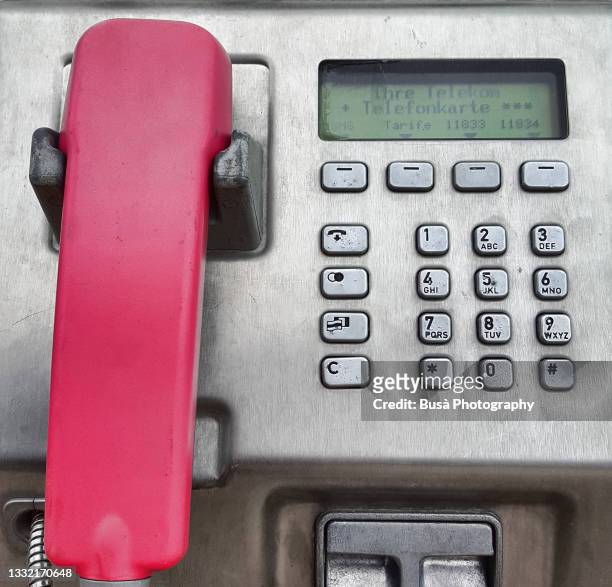 detail of public payphone with pink receiver in berlin, germany - liquid crystal display stock pictures, royalty-free photos & images