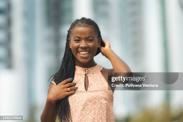 portrait of afro woman smiling outdoors - african cornrow braids stock pictures, royalty-free photos & images