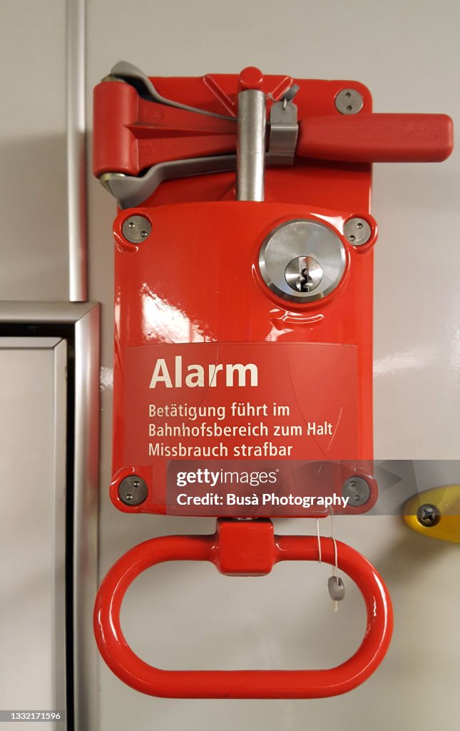 Alarm signal / emergency brake handle sign inside subway station in Berlin, Germany