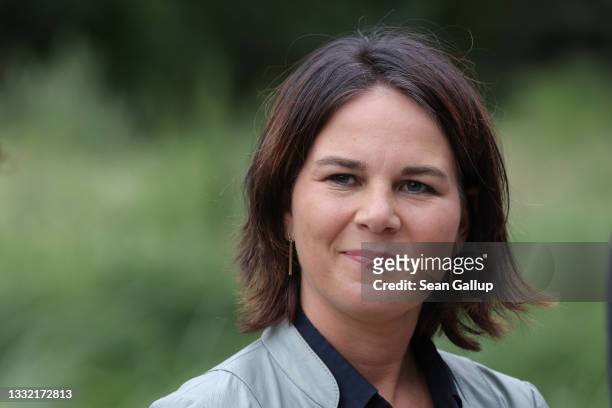 Annalena Baerbock, chancellor candidate and co-leader of the German Greens Party, speaks to the media at a campaign stop at a new park in the city...