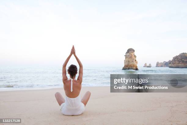 Healthy Female Meditating Along Coastlin, Foto de stock