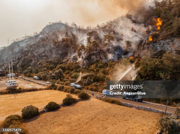 aerial view firefighter fighting forest fire - forest fire stockfoto's en -beelden