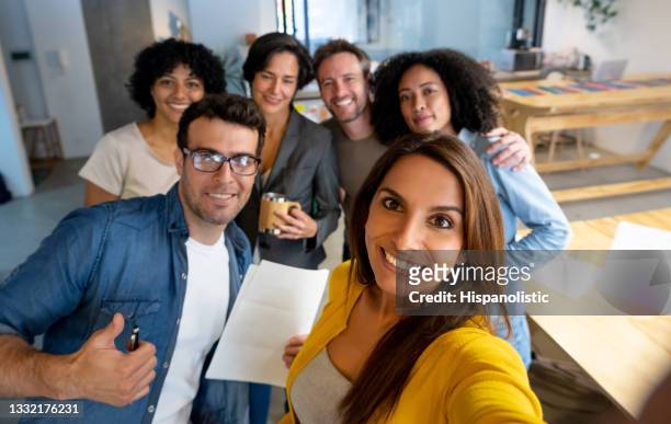 happy group of creative people taking a selfie at the office - selfie group stockfoto's en -beelden