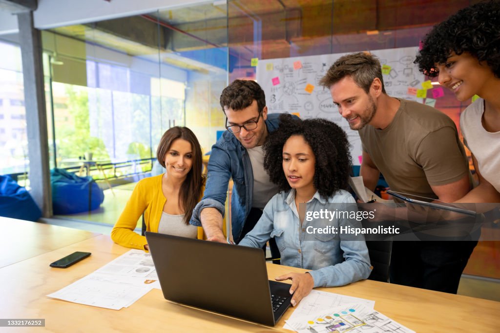 Group of designers working together in a business meeting at a creative office