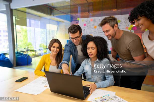group of designers working together in a business meeting at a creative office - advertises imagens e fotografias de stock