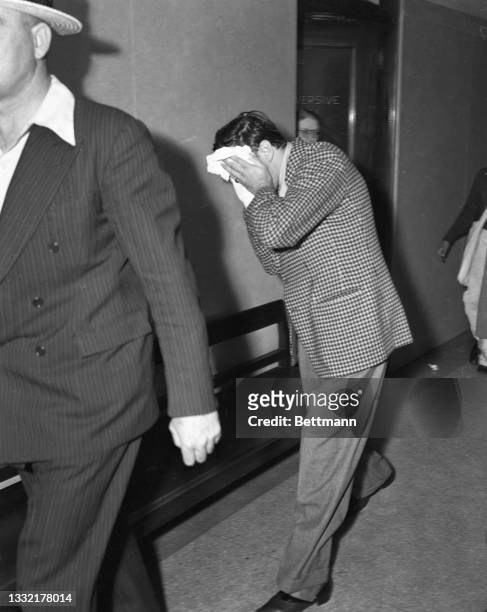 Los Angeles, CA: Benny Siegel, Hollywood night life figure, is shown after being taken from his luxurious Holmby Hills home for questioning in Los...