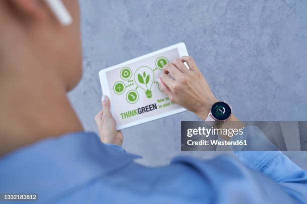 businesswoman with smart watch using digital tablet - green economy stock-fotos und bilder