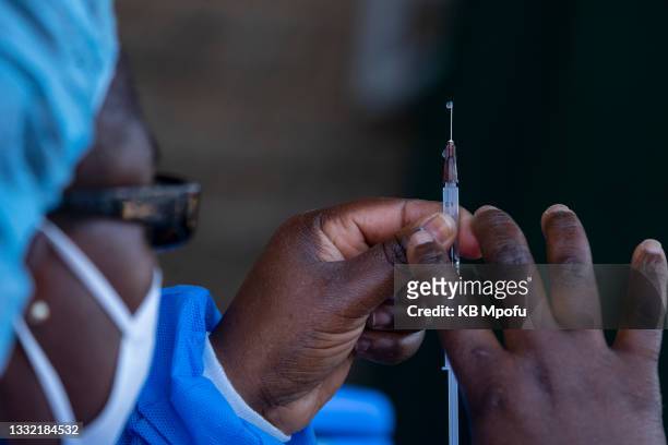 An army officer prepares to administer the Sinovac Covid-19 vaccine on August 3, 2021 in Bulawayo, Zimbabwe. Bulawayo's efforts to vaccinate at least...