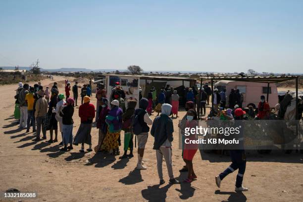 Cowdray Park residents wait patiently for their turn to get vaccinated against Covid-19 on August 3, 2021 in Bulawayo, Zimbabwe. Bulawayo's efforts...