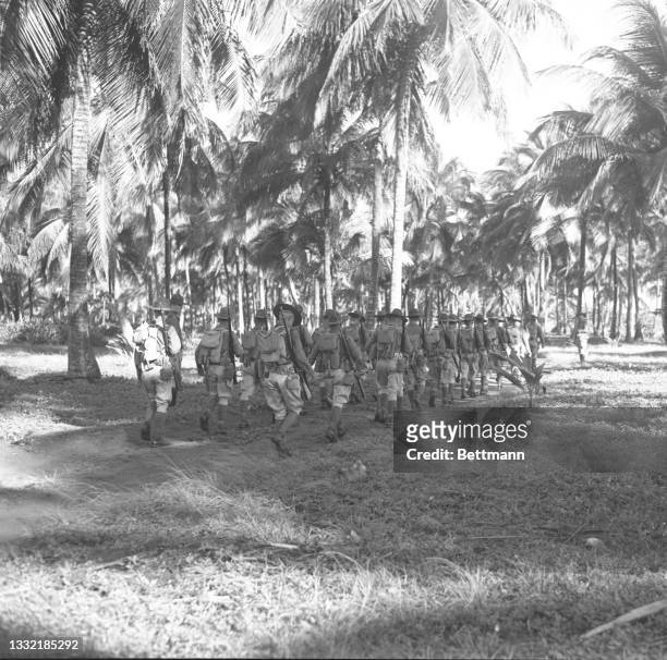Members of the 65th Infantry prepare for battle near the beach at Luquillo. Nearly ten thousand Puerto Ricans were called into service in the first...