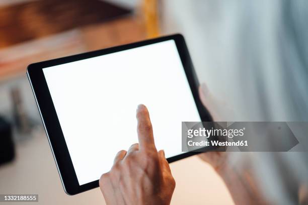 businesswoman using digital tablet at office - finger tablet stock pictures, royalty-free photos & images