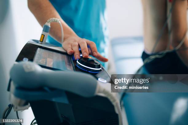 physical therapy: electrical muscle stimulation machine - electrode stock pictures, royalty-free photos & images