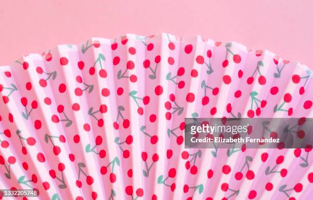 close-up of a pink fan with cherries, typical in spain. - folding fan stock pictures, royalty-free photos & images