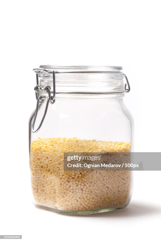 Close-up of food in jar against white background