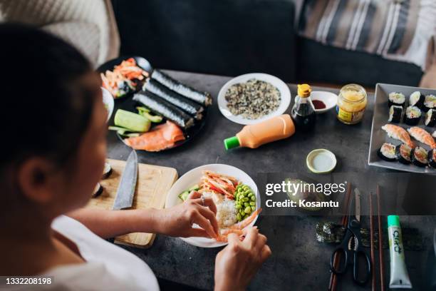 thai woman arranging the side dish plate with avocado, cucumber, shrimps and smoked salmon - making sushi stock pictures, royalty-free photos & images
