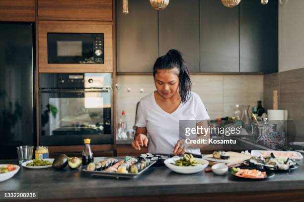 making and arranging the delicious sushi plate, with inside-out, nigiri and traditional sushi rolls - sesame stock pictures, royalty-free photos & images