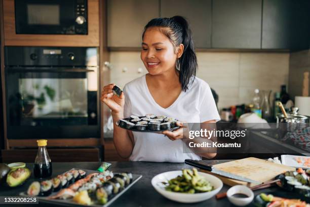 proud thai woman, holding the plate with sushi rolls she made - shrimp edamame stock pictures, royalty-free photos & images