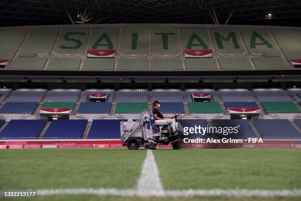 Members of ground staff tend to the pitch following the Men's Football Semi-final match between Japan and Spain on day eleven of the Tokyo 2020...