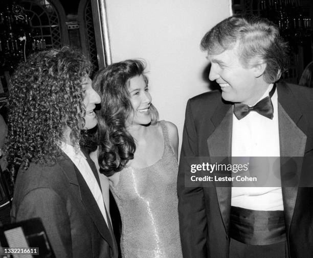 American smooth jazz saxophonist Kenny G, girlfriend Lyndie Benson and American media personality, businessman, and politician who served as the 45th...