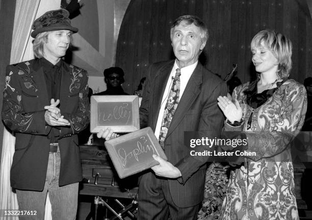 American singer, songwriter, musician, record producer, and actor Tom Petty , American mentalist The Amazing Kreskin and Petty's wife Jane Benyo pose...