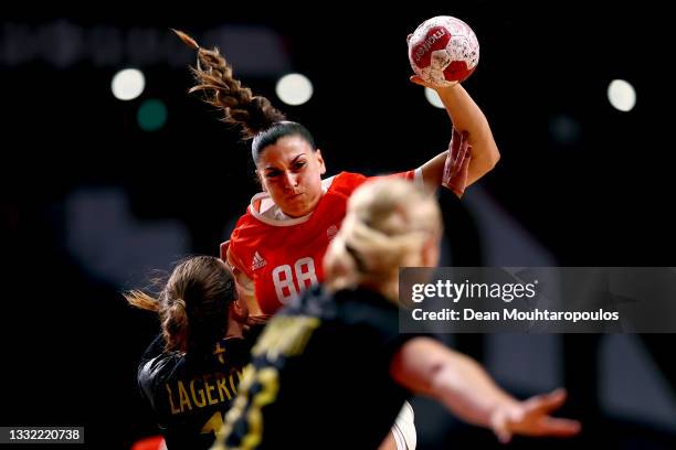 Nikoletta Kiss of Team Hungary passes the ball while being challenged by Anna Lagerquist of Team Sweden during the Women's Preliminary Round Group B...