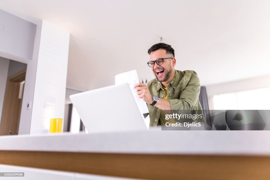 Success Through Paperwork Happy Young Man Going Through Paperwork And Celebrating High-Res Stock ...