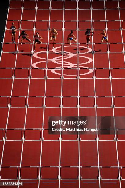 Katarina Johnson-Thompson of Team Great Britain leads the field in the Women's Heptathlon 100m Hurdles heats on day twelve of the Tokyo 2020 Olympic...