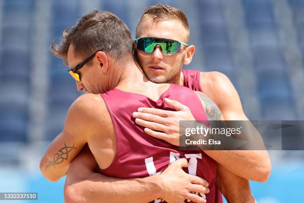 Martins Plavins of Team Latvia and Edgars Tocs celebrate after the play against Team Brazil during the Men's Quarterfinal beach volleyball on day...