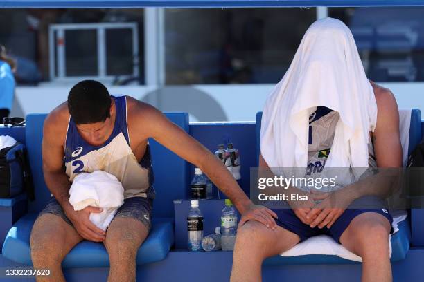 Alvaro Morais Filho of Team Brazil and Alison Cerutti react after losing to Team Latvia during the Men's Quarterfinal beach volleyball on day twelve...