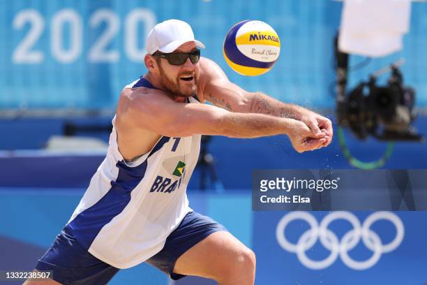 Alison Cerutti of Team Brazil returns the ball against Team Latvia during the Men's Quarterfinal beach volleyball on day twelve of the Tokyo 2020...