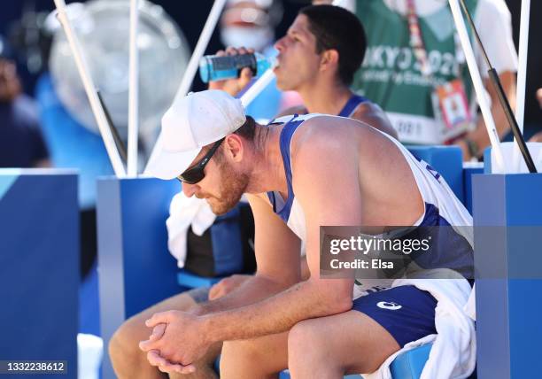 Alison Cerutti of Team Brazil reacts after losing to Team Latvia during the Men's Quarterfinal beach volleyball on day twelve of the Tokyo 2020...