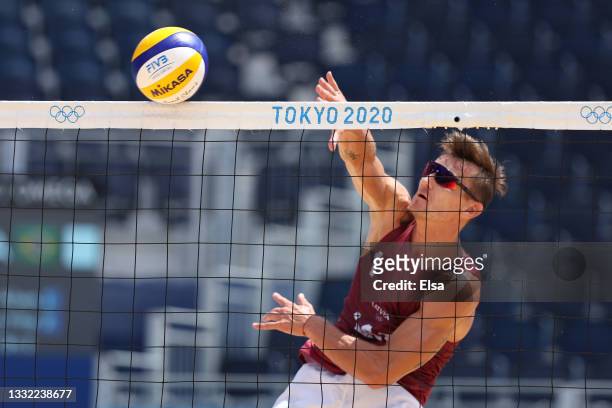 Martins Plavins of Team Latvia hits against Team Brazil during the Men's Quarterfinal beach volleyball on day twelve of the Tokyo 2020 Olympic Games...