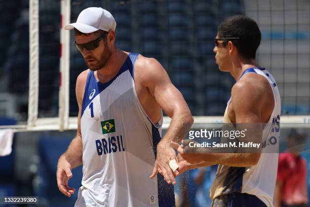 Alison Cerutti of Team Brazil and Alvaro Morais Filho react after losing to Team Latvia during the Men's Quarterfinal beach volleyball on day twelve...