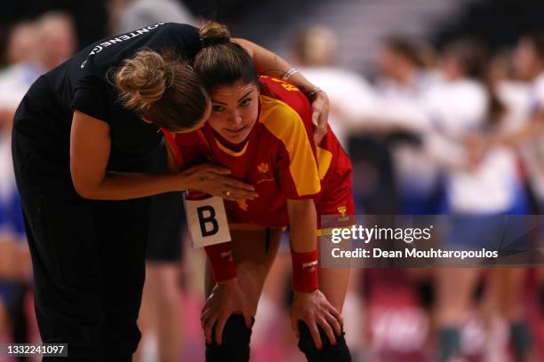 Bojana Popovic, coach of Team Montenegro consoles Jovanka Radicevic of Team Montenegro after losing the Women's Quarterfinal handball match between...