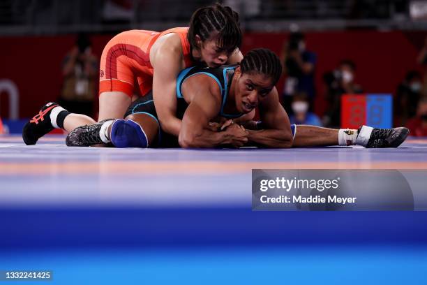 Risako Kawai of Team Japan competes against Fatoumata Yarie Camara of Team Guinea during the Women's Freestyle 57kg 1/8 Final on day twelve of the...