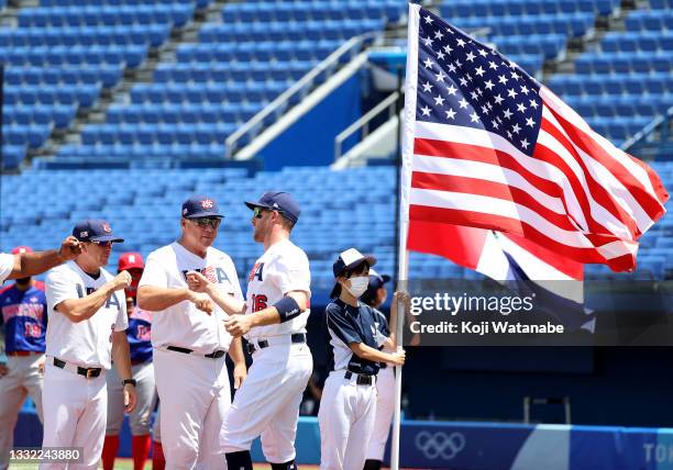 Team manager Mike Scioscia of Team United States gives a fist bump to Patrick Kivlehan as Kivlehan takes the field for pregame ceremonies during the...