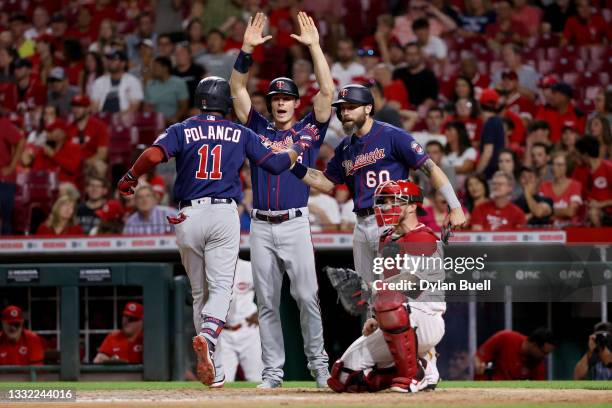 Jorge Polanco, Max Kepler, and Jake Cave of the Minnesota Twins celebrate after Polanco hit a home run in the ninth inning against the Cincinnati...