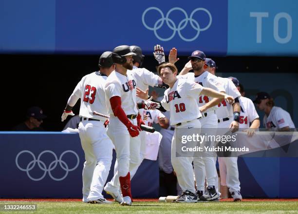 Triston Casas and Tyler Austin of Team United States are congratulated by teammates after scoring in the first inning against Team Dominican Republic...