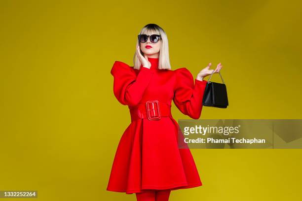 fashionable woman dresses in red - red sunglasses stock pictures, royalty-free photos & images