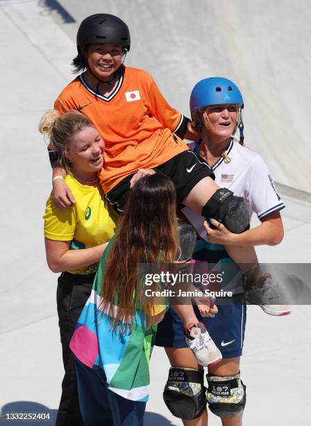 Misugu Okamoto of Team Japan is carried by Poppy Olsen of Team Australia and Bryce Wettstein of Team United States during the Women's Skateboarding...