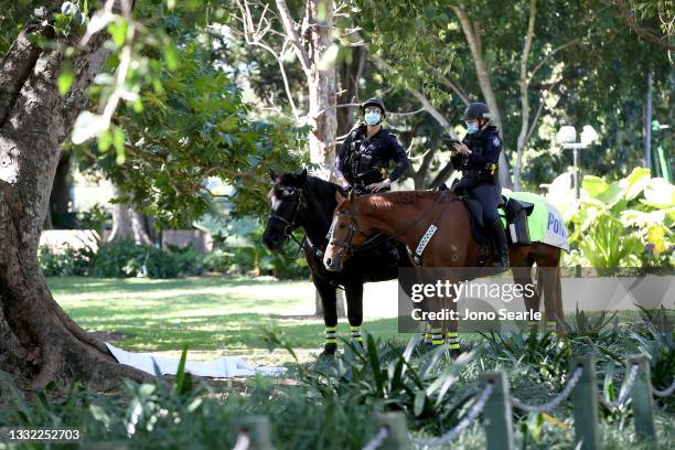 Mounted police patrol the botanic gardens on August 04, 2021 in Brisbane, Australia. Queensland is experiencing its biggest outbreak of the Covid-19...