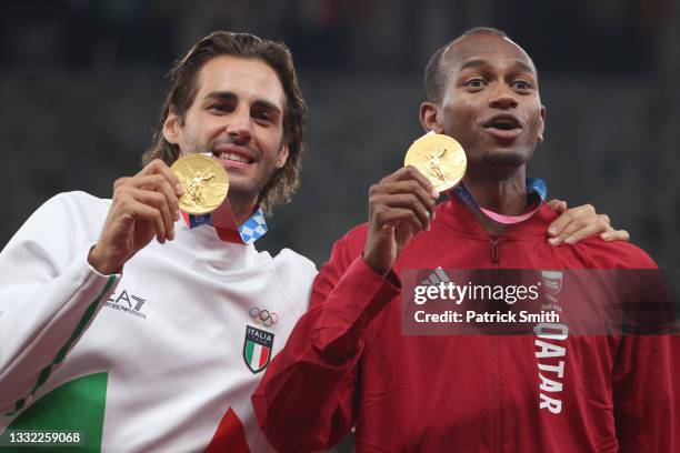 Joint gold medalists Mutaz Essa Barshim of Team Qatar and Gianmarco Tamberi of Team Italy celebrate on the podium during the medal ceremony for the...