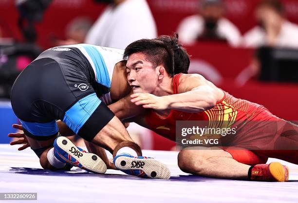 Gulomjon Abdullaev of Uzbekistan competes against Liu Minghu of China during the Men's Freestyle 57kg 1/8 Final on day twelve of the Tokyo 2020...