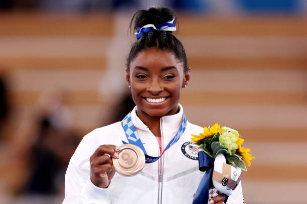 Simone Biles of Team United States poses with the bronze medal during the Women's Balance Beam Final medal ceremony on day eleven of the Tokyo 2020...