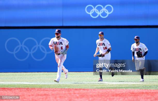 Eric Filia, Patrick Kivlehan and Jack Lopez of Team United States jog toward the infield to join teammates after their 3-1 against Team Dominican...