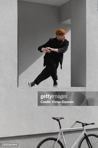 young redhead man stretches on the windowsill - turner contemporary stock-fotos und bilder