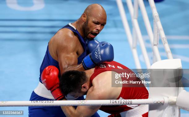 Bakhodir Jalolov of Team Uzbekistan exchanges punches with Frazer Clarke of Team Great Britain during the Men's Super Heavy semi final on day twelve...