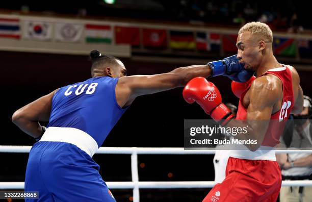 Benjamin Whittaker of Team Great Britain exchanges punches with Arlen Lopez of Team Cuba during the Men's Light Heavy final on day twelve of the...