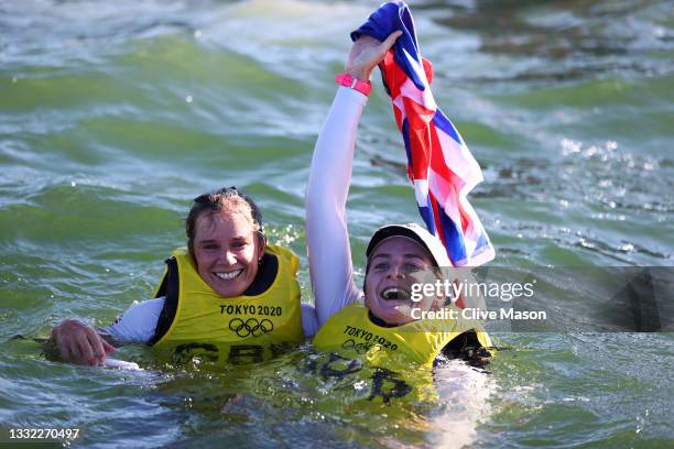 Hannah Mills and Eilidh McIntyre of Team Great Britain celebrate in the water following the Women's 470 class medal race on day twelve of the Tokyo...