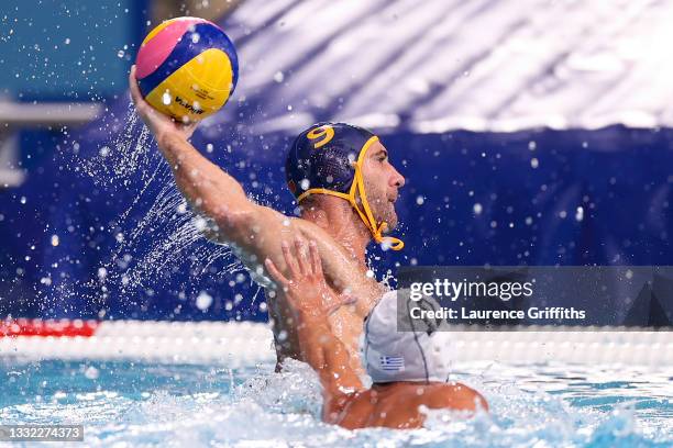Aleksander Ivovic of Team Montenegro scores a goal under pressure from Angelos Vlachopoulos of Team Greece during the Men's Quarterfinal match...